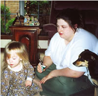 Jessica Aycock with her daughter, Jasmine, then 2, and dog, Angel. Although prednisone brought Aycock's dermatomyositis under control, it added 100 pounds to her small frame. She's now doing well on CellCept.